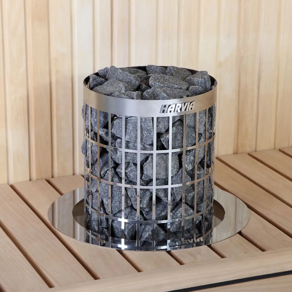 Harvia sauna heater with stones inside a wooden sauna setting by Finnish Sauna Builders
