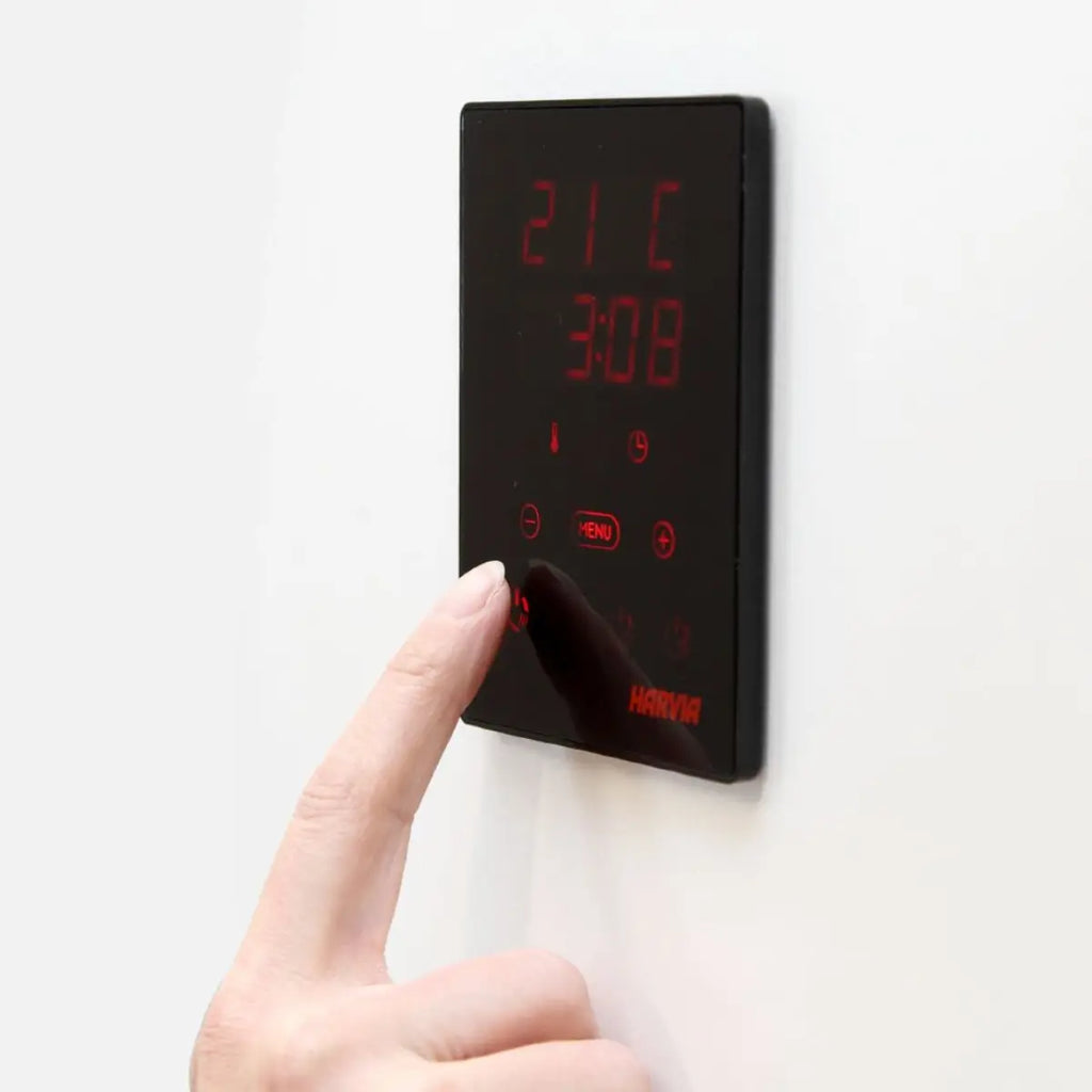 Digital temperature controller with red display on a white background by Finnish Sauna Builders