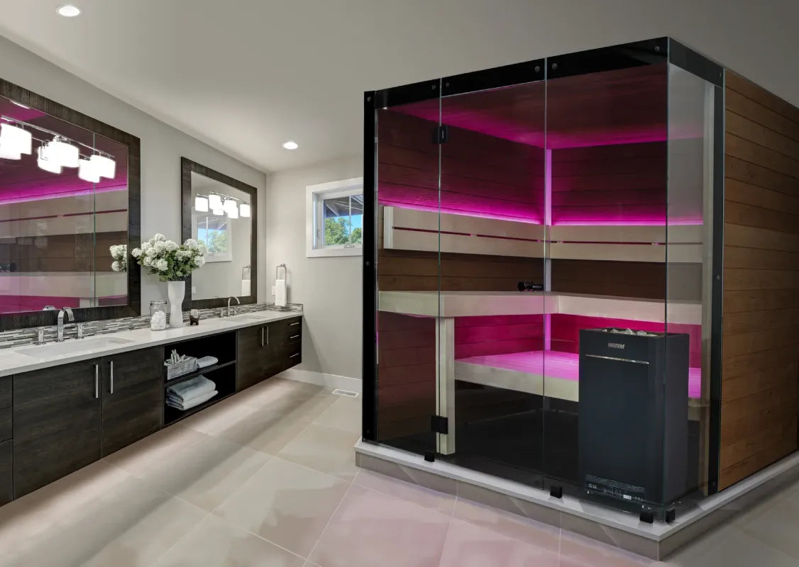 Modern bathroom with dark wood cabinets, pink LED lighting, and a freestanding bathtub.