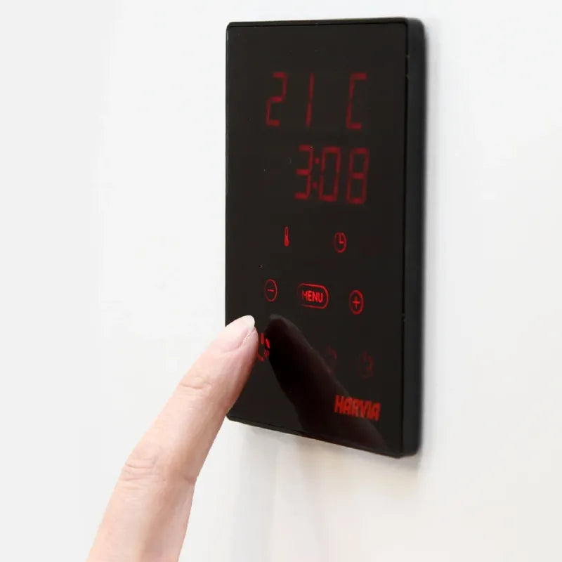 Digital wall thermostat with red display on a white background
