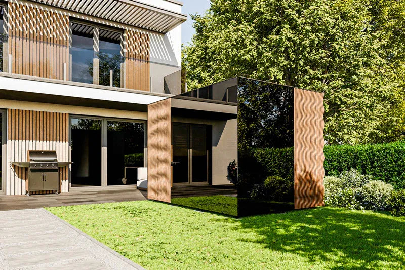 Modern house exterior with a black cube-like structure in the garden