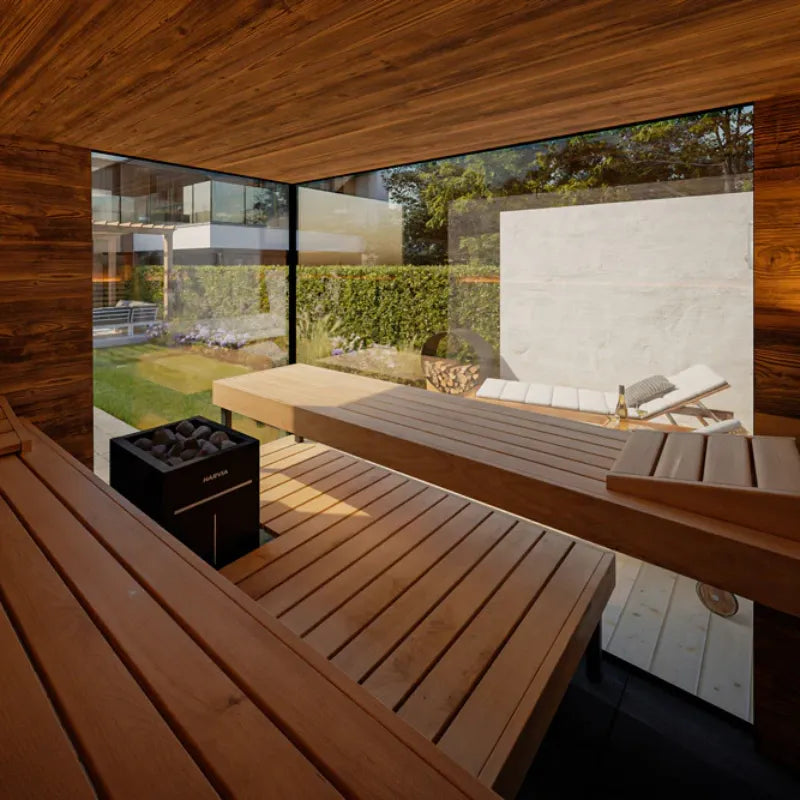 Modern outdoor patio with wooden furniture and a view of a garden.