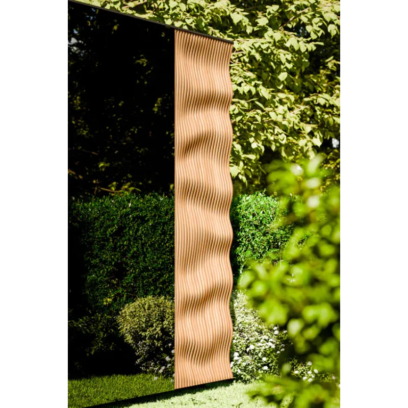Wavy patterned fabric hanging against a green leafy background