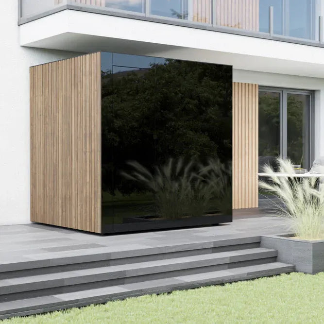 Modern house exterior with a large reflective surface and wooden paneling.